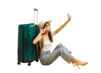 Asian beautiful woman traveler sitting nearby luggage and raised smartphone to selfies.