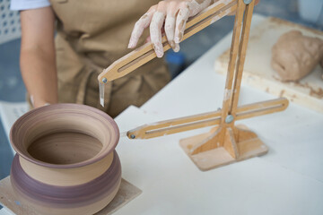 Close-up work of a master with a pottery compass