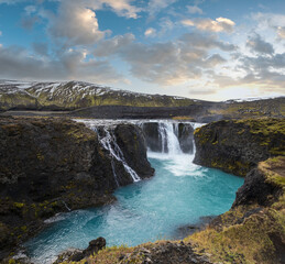 Fototapeta na wymiar Picturesque waterfall Sigoldufoss autumn view. Season changing in southern Highlands of Iceland.