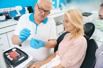 Patient on appointment with dentist in dental cabinet