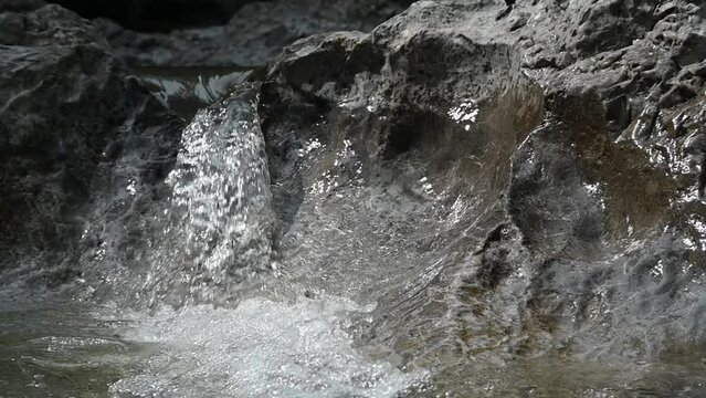 Small waterfall from a rocky mountain river, shot at f8 (slow motion)