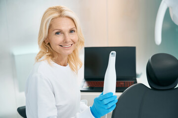 Happy woman working with machine for treatments