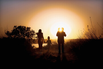 Family with children sunset walk by the river. High quality photo