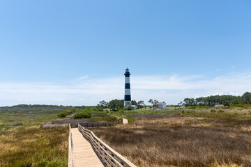 Fototapeta na wymiar Bodie Island Lighthouse, Cape Hatteras National Seashore, Outer Banks, Nags Head, North Carolina. Black and white, tall, brick tower lighthouse.