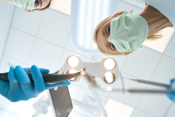 Team of medical workers filling a tooth