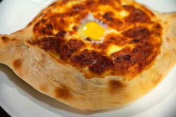 Ajarian khachapuri Georgian cheese pie with egg close