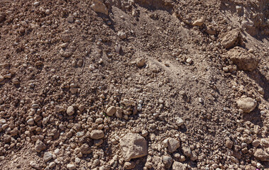 Heap of earth and small stones inside. Dried earth.
