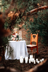 Romantic candlelit dinner in the autumn forest for lovers. High quality photo