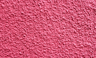 Rough texture of a wall painted with pink paint