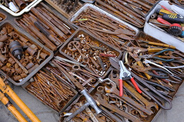 close-up showcasing old rusty metal and brass parts in bulk for decoration or collection, sold at a...