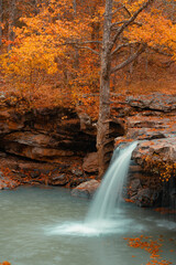 Falling Water Falls, a scenic waterfall in the Ozark Mountains of Arkansas during peak fall color.