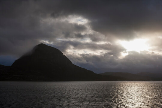 Dramatic sky over the mountain of Kunna from St&oslash;ttfjorden, Mel&oslash;y, Nordland, Norway