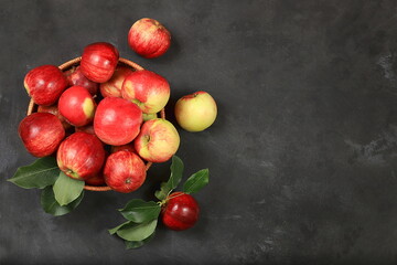 Apples in a basket on a concrete table, thanksgiving background, harvest, healthy natural food concept, detox diet and body cleansing, screen banner, cafe, restaurant, selective focus