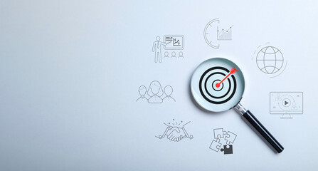 Target board inside magnifier glass on gray background. the concept of leading to the goal. learn...