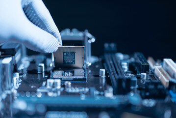 Fototapeta Repairman computer Installation CPU on socket of the motherboard. Computer technology and hardware maintenance or repair. obraz