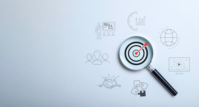 Target board inside magnifier glass on gray background. the concept of leading to the goal. learn to plan, investment strategy success, and performance growth.
