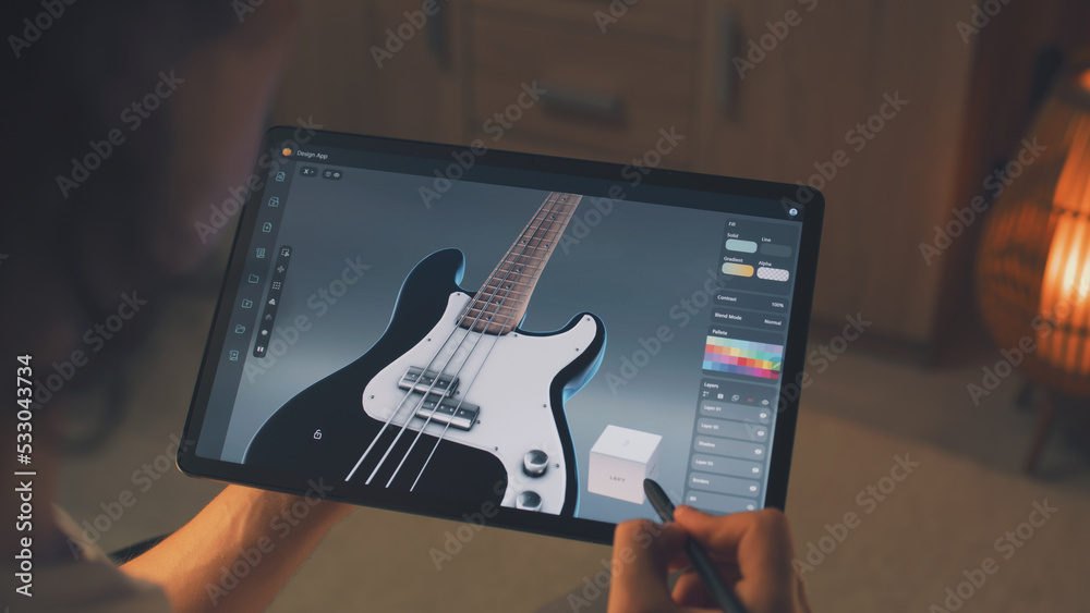 Poster Man working at home remotely and creating 3D prototype of guitar in professional program using digital tablet computer and stylus