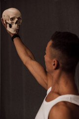 A white skull in the hands of a man. Anatomy