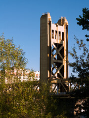 Single Tower Of Sacramento Bridge With Trees And Blue Sky