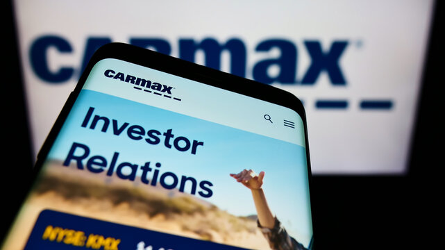 Stuttgart, Germany - 12-12-2021: Smartphone with website of US vehicle retailer CarMax Business Services LLC on screen in front of business logo. Focus on top-left of phone display.