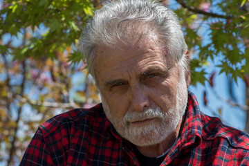 White beard man with stern look showing disapproval 