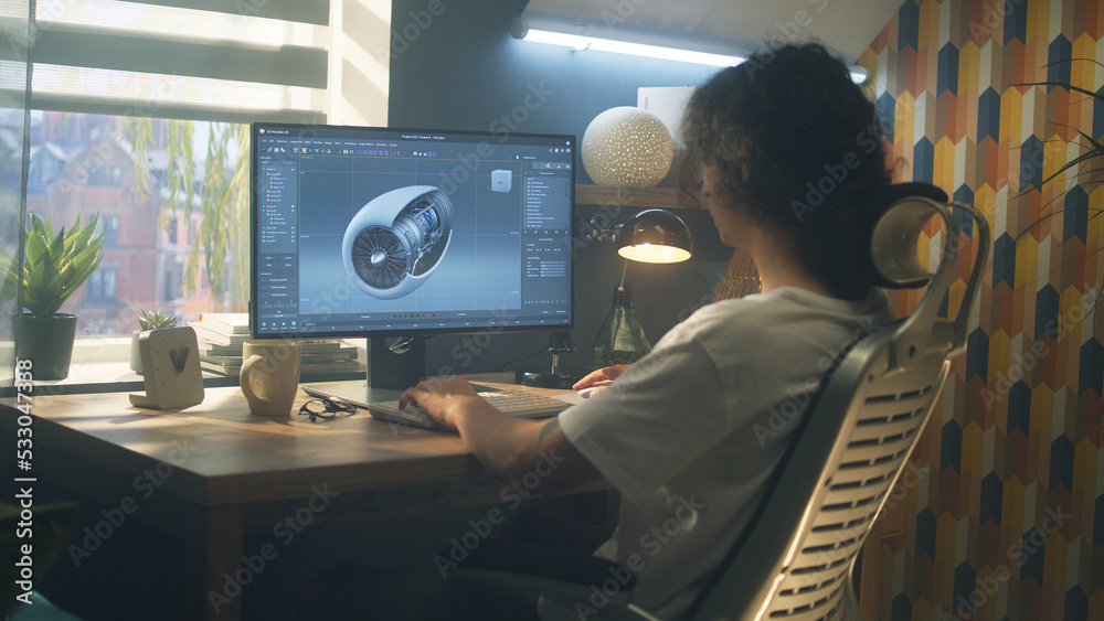 Poster male young engineer using pc with professional program and creating 3d prototype of airplane turbine
