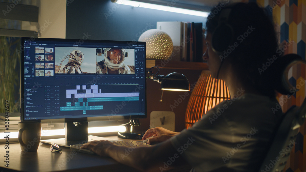 Poster guy in headphones editing video with astronauts for space blog in professional program while working