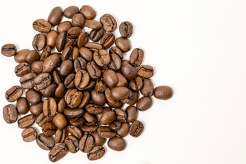 Roasted coffee beans isolated on white background, close-up.