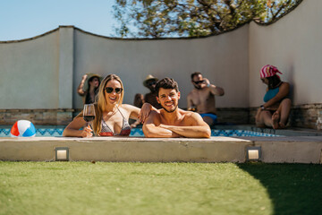 portrait of a Caucasian couple in a swimming pool looking at the camera