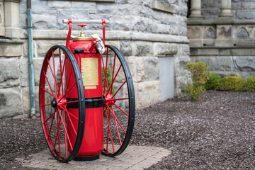 Large antique fire extinguisher on wheels