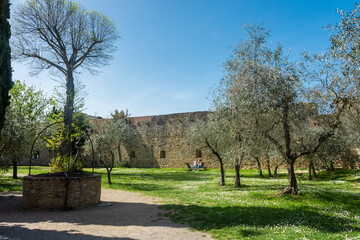 San Gimignano, Italy, 15  April 2022: Walled garden in the city center
