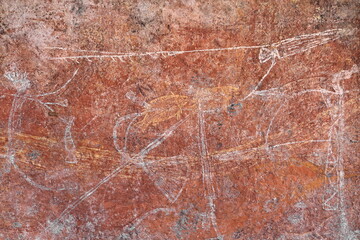 Aboriginal rock art: armed men with barbed spear-spear thrower-goosewing fan-headdress-arm ornament. Ubirr-Kakadu-Australia-197