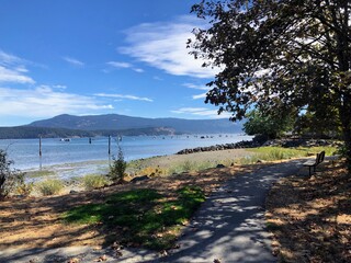 A beautiful path or walking trail looking out at Cowichan Bay, on a beautiful sunny summer day in Cowichan, British Columbia, Canada