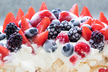Frozen fruit (strawberries, raspberries, blueberries, blackberries) on meringue and cream. Rapprochement. - 533049959