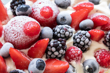 Frozen fruit (strawberries, raspberries, blueberries, blackberries) in cream. Close-up. - 533049960
