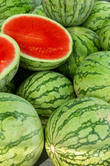 A large pile of watermelons on a market stall. - 533049981