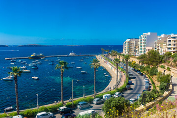 Bugibba, Malta, 22 May 2022:  View of the harbor and the promenade - obrazy, fototapety, plakaty