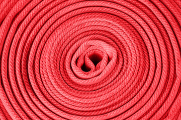 Red rolled up fire hose background, Equipment for fire fighting, top view