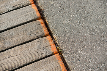 boardwalk edge spray painted with neon orange (trip hazard) and asphalt