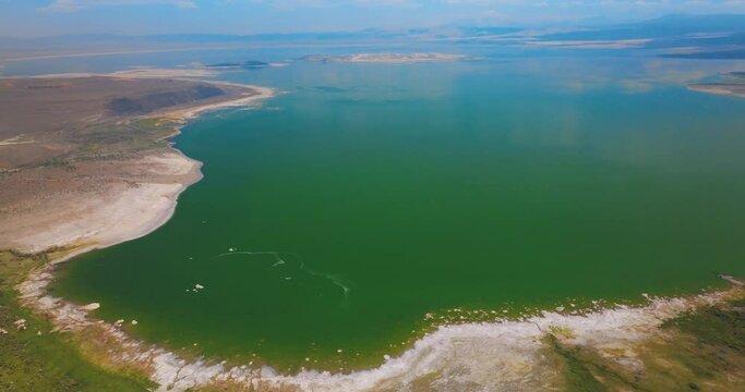 Mono Lake panorama surrounded by salty shores. Azure of the lake merging with blue sky at horizon. Top view.