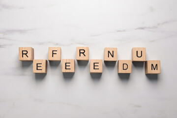 Word Referendum of wooden cubes on white marble table, flat lay