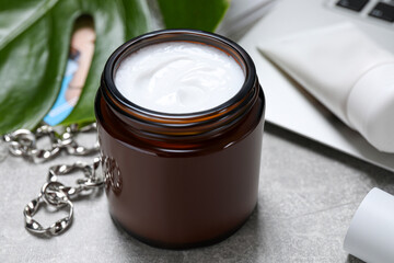 Fototapeta na wymiar Jar of hand cream on light grey table, closeup