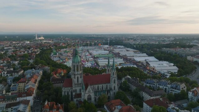 Aerial panoramic view of Theresienwiese, place where Oktoberfest is holding. Crowded site with beer tents and attractions and satisfied visitors. Munich, Germany