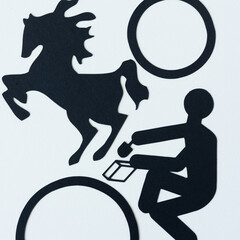 dingbat silhouettes (leaping horse and figure with scoop and bag) and paper rings