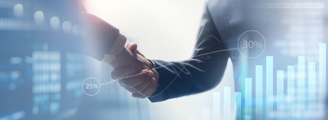 Business agreement concept. Businessmen partner handshaking with financial graph growth chart and...