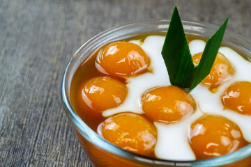Kolak biji salak ubi kuning, indonesian dessert made from sweet potatoes and sago flour which are shaped into rounds, then boiled. 
It has a delicious and chewy taste