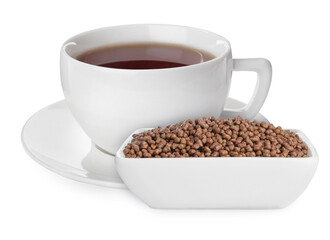 Buckwheat tea and granules in bowl on white background