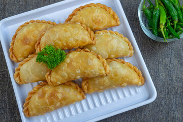 pastel goreng isi bihun, a snack containing vermicelli noodles and vegetables cooked by frying. It has a crunchy and savory texture. pastels are easy to find in Indonesian traditional markets