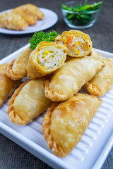 pastel goreng isi bihun, a snack containing vermicelli noodles and vegetables cooked by frying. It has a crunchy and savory texture. pastels are easy to find in Indonesian traditional markets