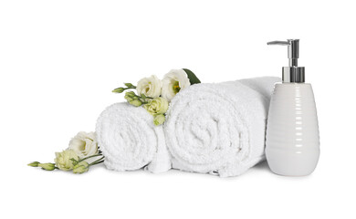 Obraz na płótnie Canvas Clean soft towels with flowers and soap dispenser isolated on white